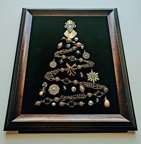 More Christmas Trees section from this shop:  https://www.etsy.com/shop/OddBeadsShoppe?section_id=45713888 Vintage Christmas Tree | Christmas tree in a frame | Christmas Tree | Christmas Tree Wall hanging | Christmas Gift What can be a better gift to yourself or your family members than a pretty vintage style Christmas Tree in a frame?  Made of beads and chains and jewelries, all carefully chosen and balanced in shapes and colors! The design is totally unique, this is a one-of-a-kind artwork, there are no exact copies of it. The elements of the Piece are attached properly and cannot be moved, replaced or detached. The piece is shipped as shown in a picture.  The vintage style frame is ready to hang on the wall or to be placed on your table on a shelf. There is no glass covering the item in A Frame Christmas, Christmas Button Crafts, Old Jewelry Crafts, Costume Jewelry Crafts, Jeweled Christmas Trees, Vintage Style Christmas, Frame Christmas, Vintage Jewelry Ideas, Jewelry Frames