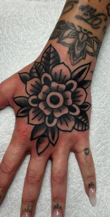 100 Hand Tattoos For Women With Style - Tattoo Me Now Hand Tattoo American Traditional, American Traditional Tattoos Hands, Lily Tattoo Hand, Hand Tattoos For Women Traditional, Black And Grey Hand Tattoos, Irish Hand Tattoos, Leg Sleeve Women Tattoo, Traditional Arm Tattoos For Women, Traditional Tattoos Hand