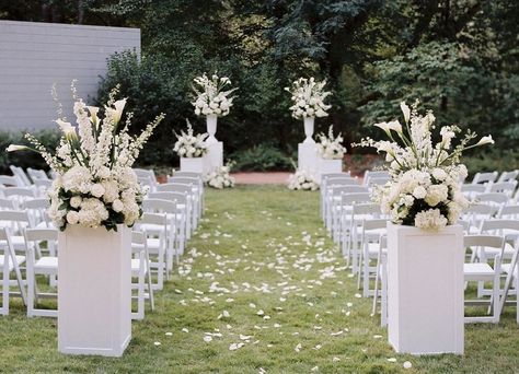 White Folding Chairs Wedding Reception, White Ceremony Chairs, Alter Flower Arrangement, Outdoor Ceremony Flowers, Wedding Pillars, Wedding Aisle Outdoor, White Wedding Ceremony, White Wedding Decorations, Wedding Alters