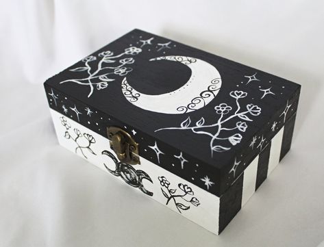 This is a hand painted tarot card box.  It can be used for anything you want, but it fits most tarot cards.  This box features a crescent moon and wildflowers.  Approximately 6 inches long, 4 inches wide, and 2.5 inches high. I only keep a few things in my etsy shop now.  My full collection of art and antiques has been moved to my website. To see all of my collection you can find it here:  https://www.wildflowermoonmagic.com/ Hand Painted Wooden Box, Jewelry Box Makeover, Painted Box, Painted Jewelry Boxes, Painted Wooden Boxes, Small Wooden Boxes, Jewelry Box Diy, Painted Jars, Painted Jewelry