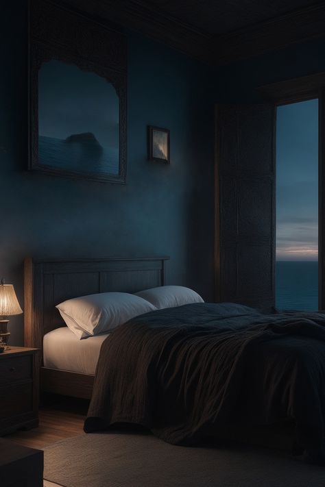 Discover this idea of a dark moody bedroom interior. The simplicity of the wooden frame bed and decorations add character to the space. The cool-toned evening light on the dark blue walls contrasts beautifully with the warm glow of a lamp. To complete the aesthetic, a framed seascape painting transports you to tranquil shores. Elevate your sleep space with this design, where every element harmoniously contributes to a serene retreat. Stormy Bedroom Aesthetic, Bedroom Ideas Dark Walls, Dark Blue Wallpaper Bedroom, Monochromatic Blue Bedroom, Cosy Dark Bedroom, Midnight Blue Room, Dark Blue Moody Bedroom, Midnight Blue Bedroom Ideas, Dark Blue Room Bedroom