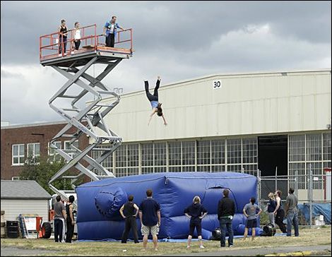 Inflatable stunt pads are used to allow stuntmen to jump from large heights and survive. They achieve this by using the principles of momentum and impulse. Then as he exerts a force on the pad the pad provides a small bit of resistance.Then over the next few seconds as the person keeps falling the pad slowly slows him down to a stop with its gradual resistance. By using the method to gradually slow him down the momentum of the stuntman gradually lessens over time which is what impulse is. Physics Projects, Stunt Woman, Mercer Island, My Bucket List, Downtown Los Angeles, Water Cooler, News Media, Unique Things, Movies Online