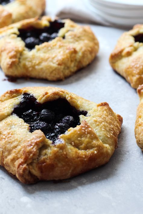 Blueberry Galettes are a delicious summer treat. They're made with a blueberry filling that has a hint of lemon and a cornmeal crust that is folded over for a rustic dessert. Serve this as a breakfast pastry or an afternoon treat with a scoop of vanilla ice cream. #blueberrygalette #cornmealcrust #thesweetoccasion Cornmeal Crust, Blueberry Galette, Blueberry Orange, Chocolate Hazelnut Cookies, Completely Delicious, Orange Dessert, Rustic Dessert, Hazelnut Cookies, Fruit Filling