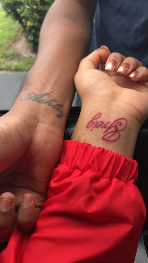 Names On Wrist Tattoos, Red Ink Name Tattoo, Mom Name Tattoo For Men, Matching Name Tattoos, Name Tattoos Men, Couples Name Tattoos, Partner Name Tattoos, Girlfriend Name Tattoo, Boyfriend Name Tattoos For Women