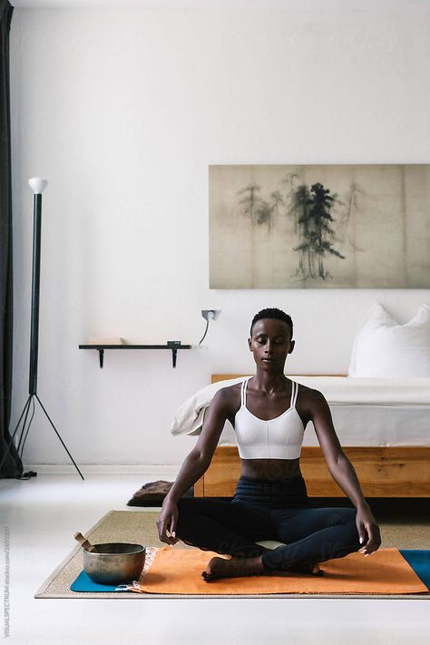 A slim and attractive black woman meditating with eyes closed on the floor in a beautiful white bedroom. The large print of Japanese pine trees is in the public domain. Black Woman Meditating, Woman Meditating, Yoga Poses For Back, Yoga Photoshoot, Outfit Yoga, Downward Dog, Pose Yoga, Pilates Studio, Eyes Closed