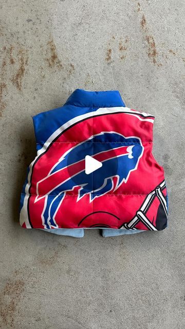 Upcycled gameday outfits on Instagram: "Puffer vest upcycled out from a vintage Buffalo Bills flag. Just about anything can be re-imagined onto a basic pattern. I did not make this pattern, I bought it off etsy! Will link the one i used in my bio :) Should I make more of these?? Got inspired to use this pattern after I saw @kristinjuszczyk make a 49ers one. I love how mainstream upcyling has become. Being intentional with the resources we already have is always more ethical than buying new. When you try this pattern, challenge yourself to use materials that are already in your closet (minus the thread and stuffing obviously, lol) Can’t wait to see what you guys create :)" Bills Game Day Outfit, Game Day Diy Outfit, Football Sewing Projects, Diy Puffer Vest, Buffalo Bills Outfit Woman, Buffalo Bills Diy, Vest Pattern Sewing, Buffalo Bills Outfit, Sports Jersey Outfit