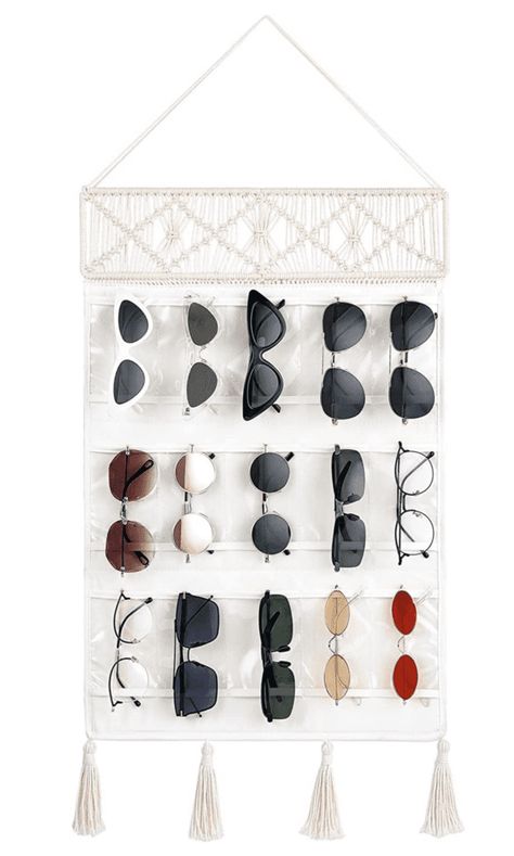 Sunglasses are a summer essential, but they can be a pain to store properly. If you’re not careful, the lenses can get scratched and the frames can become bent. Not to mention, it can be difficult to find them in a cluttered sunglasses drawer! That’s why we’ve put together a list of 10 creative ways... The post 13 Creative Ways to Store Your Sunglasses to Keep Them In Good Condition first appeared on Practical Perfection. Eyewear Display, Glasses Storage, Sunglasses Organizer, Decorative Tassels, Sunglasses Storage, Tassels Decor, Closet Accessories, Door Hooks, Macrame Hanging