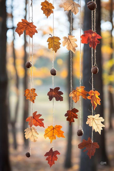 Hanging autumn leaves and pinecones in a forest setting. Cozy fall decor idea, perfect for adding a touch of fall home decor to your space. Autumn Leaf Garland Diy, Fall Leaves Decorations, Autumn Leaf Decorations, Thanksgiving Craft Decorations, Nature Party Decor, Anthropologie Fall Window Display, Nature Party Decorations, Paper Leaf Decor, Leaf Decoration Ideas