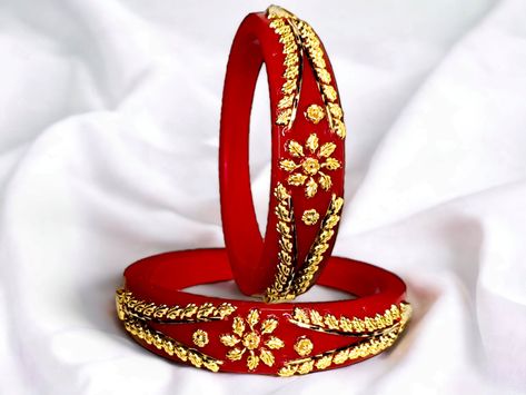 Introducing our exquisite Handmade Gold Plated Plastic Deep Red Pola Bangles Set of 2, inspired by the renowned Motu Patlu Pola from India. These beautiful bangles are crafted with care in West Bengal, India. Made with the finest materials, they add an elegant touch to any outfit. Pair them with traditional attire or contemporary ensembles for a stunning look. Materials: Gold plated plastic.  Care Instructions:                       Avoid contact with water and perfume.  Model Name                                Gold Plated Motu Patlu pola Bangles Ideal For                                       Women Type                                               Bangles Base Material                               Plastic Bangle Size                                  2-4, 2-8, 2.6 Stretchable Perfume Model, Motu Patlu, Traditional Bangles, Beautiful Bangles, Plastic Bangles, Bangles Set, Traditional Attire, West Bengal, Handmade Gold