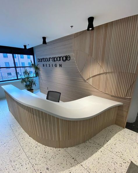 Justin Stabb on Instagram: "It was a pleasure bringing this reception desk to life, designed by @barbourspangle for their new office in @congdonyards. Be sure to check out the thermal formed corian and the logo integrated into the back wall. . . . . #receptiondesk #carpentry #corian #interiordesign #architecture #millwork" Arch Reception Desk, U Shaped Reception Desk, Check In Counter Design, Rounded Reception Desk, Curvy Reception Desk, Oval Reception Desk, Curved Reception Desk Design, Reception Back Wall Design, Organic Reception Desk