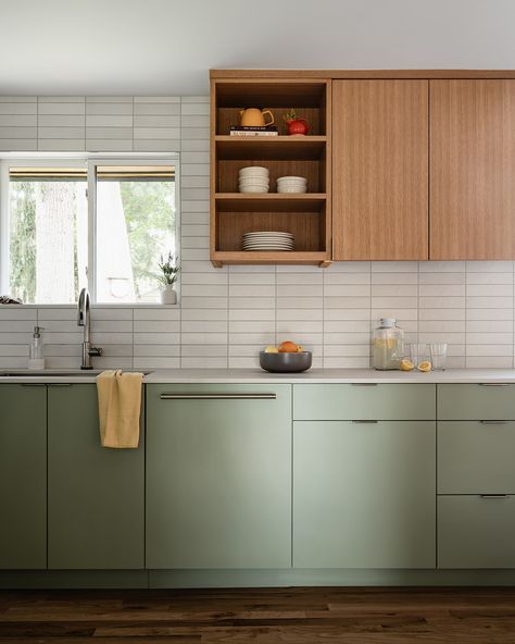 This kitchen features sleek, minimalistic cabinetry in a soft, pale green hue and a complimentary wood. The goal was to create a refreshing and contemporary ambiance while paying homage to the home's Mid-Century architecture. I think our talented team nailed it!⁠ 🙌🏻⁠
⁠
Check out The Home Code w/ Suzy Scott coming soon!⁠
⁠
#thehomecode #skinteriors #suzannekristineinteriors Sage Green And Oak Kitchen, Green Oak Kitchen, Sage Green And Wood Kitchen, Green And Oak Kitchen, Contemporary Green Kitchen, Pale Green Kitchen, Mid Century Architecture, Oak Kitchen, Room Update