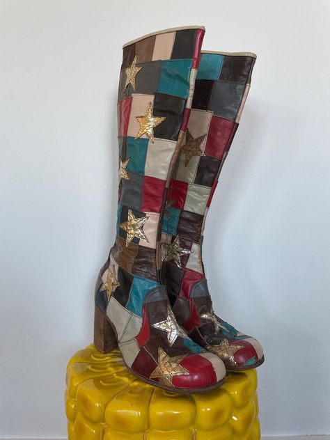 "ITEMS PURCHASED BETWEEN 11/20-1130 WILL SHIP 12/1  Andy from JJ Flash would fly to England and have these boots custom made.  As is, no returns. See full description and images. Iconic early 1970s glam rock boots. Patchwork outer with red, teal, plum, black, brown, and grey leather. Silver snakeskin stars appliqued on top. Lined in solid brown leather. Interior zipper and wooden stacked block heel. \"Made in England\" faintly stamped on the bottom. Damage notes: Wear consistent with age. Some s Glam Rock Boots, 1970s Glam Rock, 70s Rockstar, 1970s Glam, Thought Daughter, Dr Shoes, Shoe Wishlist, Funky Shoes, Leather Patchwork