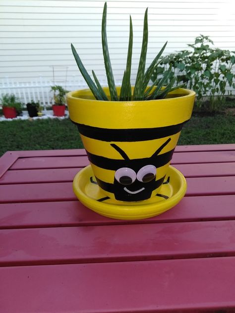 Acrylic paint,  acrylic sealer,  Rubberbands,  glue gun, terracotta pot, paint brush and foam brush. Sunflower Terra Cotta Pot, Bumble Bee Flower Pot, Bumble Bee Clay Pots, Bee Terra Cotta Pot, Terracotta Animal Pots, Bumblebee Painting, July Activities, Garden Pergola, Planting Pot