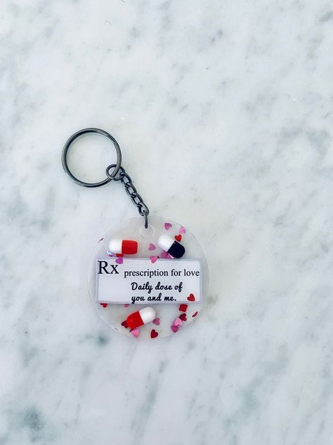 "LOVE this \"Rx Prescription for Love Daily Dose of You and Me\" epoxy resin keychain made to order by yours truly, the happy pharmacist. The keychain ring is gunmetal black.Xoxo Resin circle circumference is 2 inches. Cardstock quote is inside of resin. Heart confetti and black/white resin capsules are an added touch! I ship each item with care and a little note sharing my story as a crafty pharmacist and why I believe in capsule art. *WARNING: Capsules are for decorative purposes only and are Unsatisfying Pictures, Baby Boy Background, Keychain Resin, Love Keychain, Keychain Ring, Heart Confetti, Resin Keychain, Pharmacist, Yours Truly