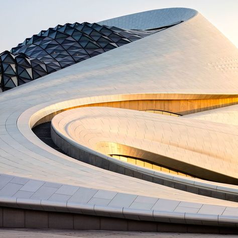 Designed by MAD Architects, the Harbin Opera House in northern China features a sculptural lobby with timber-clad balconies and stairs. Harbin Opera House, Mad Architects, مركز ثقافي, Arsitektur Masjid, Rem Koolhaas, Parametric Architecture, Harbin, Organic Architecture, Zaha Hadid