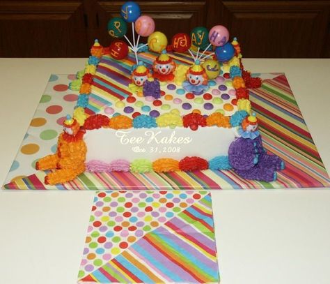 CAKE BOARD FOR RHYS CIRCUS CAKE Customer requested a carnival theme cake to match the party napkins and this is what I came up with. I was lucky to find two different papers to cover the board in and match the napkin very closely! Lots of fun making this cake! French vanilla cake and filling. Buttercream frosting and decorations. Clown heads and balloons are the plastic ones. Carnival Theme Cake, Carnival Themed Cakes, Carnival Birthday Cakes, Circus Birthday Cake, Circus Cakes, Birthday Animals, Clown Cake, Carnival Cakes, French Vanilla Cake