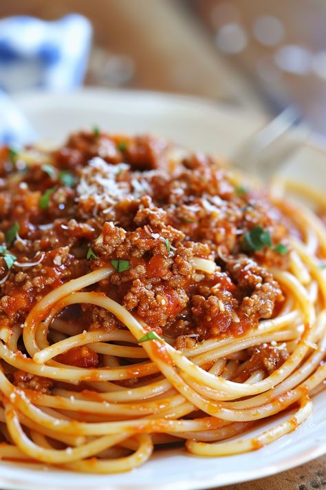 Indulge in a delicious homemade meal tonight with spaghetti with meat sauce. This classic Italian dish is perfect for a cozy night in or a family dinner. Our recipe is simple to follow and will have your taste buds dancing with every bite. The combination of flavorful ground beef simmered in rich tomato sauce served over perfectly cooked spaghetti noodles is sure to satisfy any pasta craving. Spice it up with your favorite seasonings and top it off with some freshly grated Parmesan cheese for th Ground Beef For Pasta, Spaghetti Recipes For Two, Beef Pasta Sauce Recipes, Hamburger Meat Spaghetti Recipes, Spaghetti Recipes Without Tomato Sauce, Spaghetti And Ground Beef, Beef Pasta Recipes Italian, What To Cook For Boyfriend, Ground Meat Spaghetti Recipes