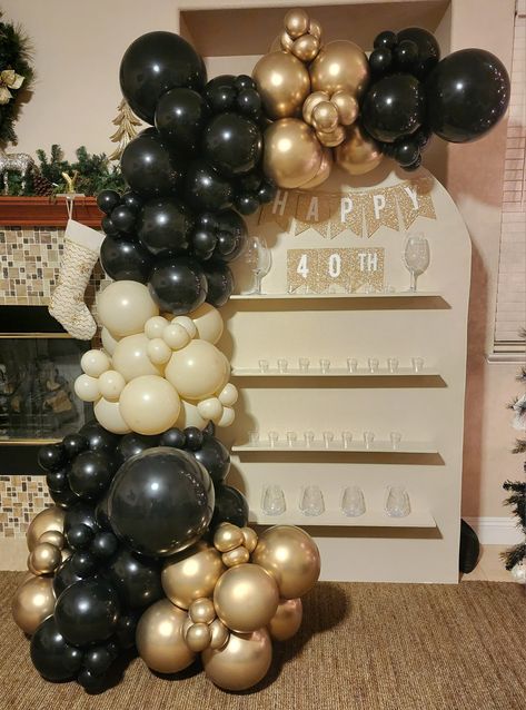 40th Birthday Champagne wall backdrop, shot glass panel, balloon garland Black Gold Champagne Balloons, Champagne Wall Balloon Garland, Black Gold And Cream Balloon Garland, Champagne Wall With Balloons, Black Gold Balloon Garland, Champagne Backdrop, Black Balloon Garland, Gold Balloons Decorations, 50th Birthday Party Ideas For Men