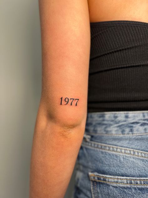 Birth Year Tattoo Above Elbow, Year Born Tattoo Ideas, Birth Year Tattoo Elbow, 1967 Tattoo Date, Dates On Back Of Arm Tattoo, Year Tattoo On Wrist, 1982 Tattoo Font, Parents Year Of Birth Tattoo, 2 Dates Tattoo