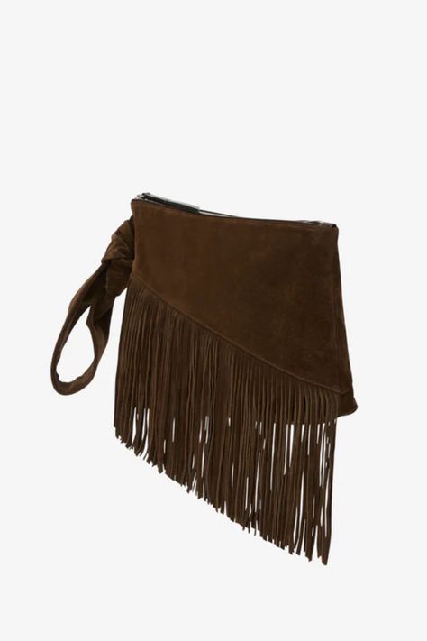 Carry a little fun with you wherever you go with the Isabel Marant Faro Clutch Bag in Bronze. This mini bag features a zipper closure and zippered interior pocket for secure storage, while the fringe details and topstitching add a playful touch. Perfect for hand carrying your essentials in style. Available in Bronze 100% calf velvet leather Imported Height: 8.25in, Length: 13.75in, Depth: 2.75in, Strap drop: 8.75in Shop more women's designer handbags here. About Isabel Marant Isabel Marant created her namesake line in 1994, followed by a moderately-priced line named Isabel Marant Etoile in 1999. Inspired by pieces she found in her father’s closet, her aesthetic is chic with a tomboy flair. From her iconic shoes to her colorful jewelry, every piece is cool and highly coveted. Cocktail Essentials, Suede Clutch, Womens Designer Handbags, Mini Pouches, Styl Boho, Fringe Trim, Wrist Strap, Isabel Marant, Valentino Garavani