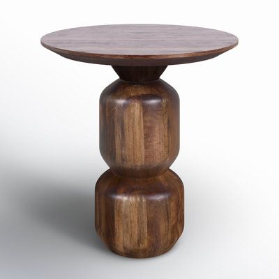 We love having an extra surface to rest drinks and other quick-grab items. Our round end table is a great addition for your living room or den setup. Crafted from solid mango wood, it comes in a warm dark brown tone with a lacquered finish up top that highlights natural grain variation for a hint of rustic charm. The pedestal base shows off a stacked silhouette, bringing a hint of geometry and mid-century modern style to your space. AllModern Rafaella Solid Wood Pedestal End Table in Brown | Siz Highlights Natural, Pedestal End Table, Wood End Table, Round End Table, Wood Accent Table, Brown Tone, Wood Pedestal, Outdoor Side Table, Wood End Tables