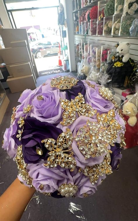 This silk flower bouquet is designed specifically for Quinceañeras, adding a touch of elegance and tradition to the special celebration. Crafted with high-quality silk flowers, it will beautifully accentuate the attire of the Quinceañera and serve as a lasting keepsake. Purple Quinceanera Bouquet, Purple And Gold Flowers, Quinceanera Ramo, Purple Quinceanera, Quinceanera Bouquet, Silk Flower Bouquet, Purple Bouquets, Quince Hairstyles With Crown, Wedding Headpieces