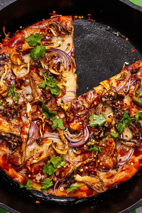 This recipe is a vegetarian twist on the California Pizza Kitchen fan favorite, BBQ Chicken Pizza. All of the heavy hitters are the same: tangy barbecue sauce, melty cheese, and sweet red onion. But instead of chopped chicken breast, the meaty component is mushrooms, which go crispy and tender in the oven in a way that chicken never could. With store-bought pizza dough and your favorite barbecue sauce on deck, it’s a recipe that comes together in minutes, no trip to the mall required. Bbq Mushrooms, Mushroom Pizza Recipes, Store Bought Pizza Dough, California Pizza Kitchen, California Pizza, Bbq Pizza, Mushroom Pizza, Pizza Kitchen, Bbq Chicken Pizza