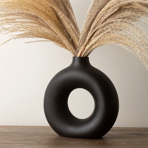 PRICES MAY VARY. PAMPAS VASE FOR BLACK ROOM DECOR - The black modern vase is ideal for minimalist decor; its circle vase with hole, round black shape offers aesthetic vase accent,for blackfarmhouse decor, black bedroom decor. Material: 100% ceramic vase, this textured vase has matte finish on the surface, slightly rough to the touch which feels vintage and rustic, size: 19cm*18cm*6cm/7.5inches*7inches*2.4inches. Shape: Donut/doughnut. Color: black. Weight: 1.9lbs/860grams. BLACK CERAMIC VASES FO Black Matte Vase, Black Vase Decorating Ideas, Black And Tan Decor, Fall Vase Decor, All Black Decor, Classy Fall Decor, Tall Black Vase, Modern Bedroom Accessories, Pampas Vase