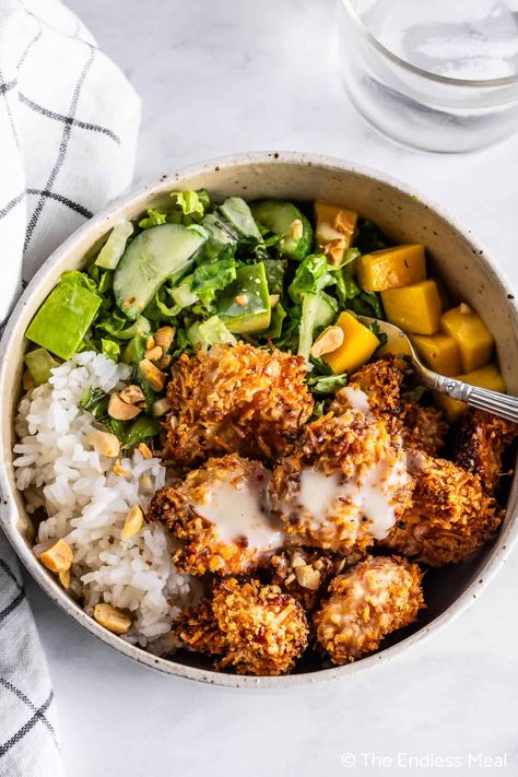 Crispy, incredible, and over-the-top delicious coconut shrimp bowls make the best dinner. If you're short on time, I have an easy kitchen hack to help you get these bowls on the table in just 20 minutes! #theendlessmeal #dinner #coconutshrimp #shrimp #coconut #shrimpbowls #dinner Coconut Shrimp Bowl, What To Serve With Coconut Shrimp, Coconut Shrimp Meal, Cajun Shrimp Bowl, 400 Calorie Dinners, Coconut Shrimp Dinner, Coconut Shrimp Salad, Shrimp Bowl Recipe, Peanut Shrimp