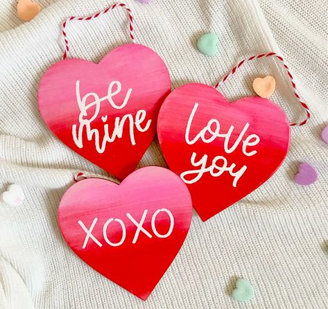 "Get into the Valentine's Day spirit with a mini heart hanging sign! These signs were DIY'd with lots of love for Valentine's Day and to spread love all year round. Three fun designs to choose from or the option to customize your own! Designs include: -Be Mine -Love You -XOXO -CUSTOM --------------------------- Product Details: -4\" wooden hearts -Hand painted with heat embossed lettering -Red + white twine for easy wall hanging" Valentines Day Decor Rustic, Wooden Hearts Crafts, Heart Home Decor, February Crafts, Valentine's Day Decor, Heart Painting, Valentines Art, Diy Valentines Crafts, Love Sign