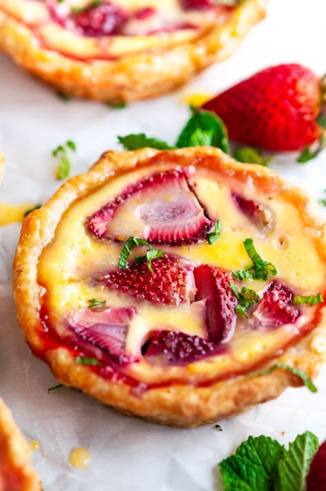 Strawberry Honey Custard Tarts with Lemon Curd - A yogurt based custard sweetened with honey and fresh strawberries in a flaky, golden pie crust and then topped with a drizzle of homemade lemon curd. From aberdeenskitchen.com #strawberry #honey #custard #tart #lemon #curd #spring #summer #easter #dessert #baking #recipe Strawberry Tarts, Strawberry Honey, Homemade Lemon Curd, Custard Tarts, Custard Tart, Baking Recipe, حلويات صحية, Think Food, Easter Dessert