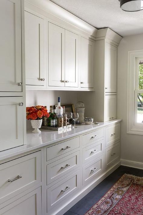 Traditional style butler's pantry and bar features ivory shaker cabinets adorned with polished nickel hardware paired with white quartz countertops. Traditional Laundry Room, Dining Room Built In, Built In Buffet, Pantry Laundry Room, Pantry Wall, Dining Room Buffet, Kitchen Pantry Design, White Quartz Countertop, Butler Pantry