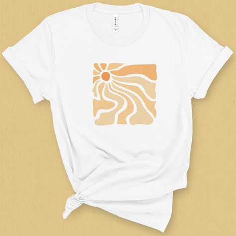 Here comes the sun! Let those sunny rays reach out and warm your soul, with this trippy sun graphic tee. With its chill nod to California beach style, this t-shirt is sure to put you in that lazy beachy happy mood. DETAILS This medium weight graphic t-shirt is super soft, comfy. It fits like a well loved favorite tee the first time you put it on, and is soon to become your go to tee. This durable crew neck, short sleeve shirt is made with superior combed and ring-spun cotton sure to flatter any Sun T Shirt Design, Groovy Graphic Tee, Beach Shirt Design Graphic Tees, Sun Tshirt Design, California Beach Style, Trippy Sun, Good Vibes T Shirt, Sun T Shirt, Sun Graphic