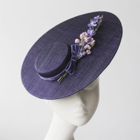 Jardin de Nuit Straw hat with Flowers by And They Loved Hats. Inspired by nature to create an elegant, unique and charming design. This beautiful and dramatic silhouette is made in multiple layers of the finest woven straws, in a regal shade of deep dark purple, to create a carefully designed romantic hat, trimmed with perfectly placed preserved flowers. The hat is held in place with a metal headband. A hat made to stand out from the crowd. Perfect for your special events and evening soirees, Mo Evening Hat, Hat With Flowers, Dramatic Silhouette, Derby Outfits, Ladies Luncheon, Couture Hats, Ascot Hats, Metal Headband, Elegant Hats