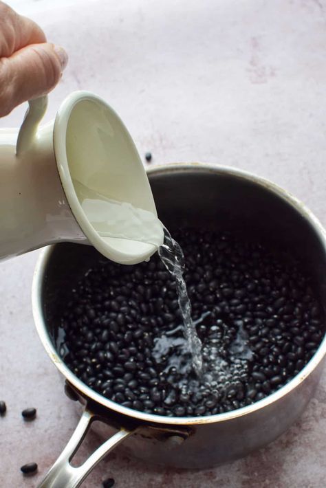 a pot full of dried black beans.  A jug of water is being poured on top of the beans. Fast Soak Dry Beans, How To Cook Dry Beans Fast, Quick Soak Dry Beans, Quick Soak Beans, Soaking Beans, Soak Beans, Dry Beans Recipe, Cook Beans, Homemade Beans