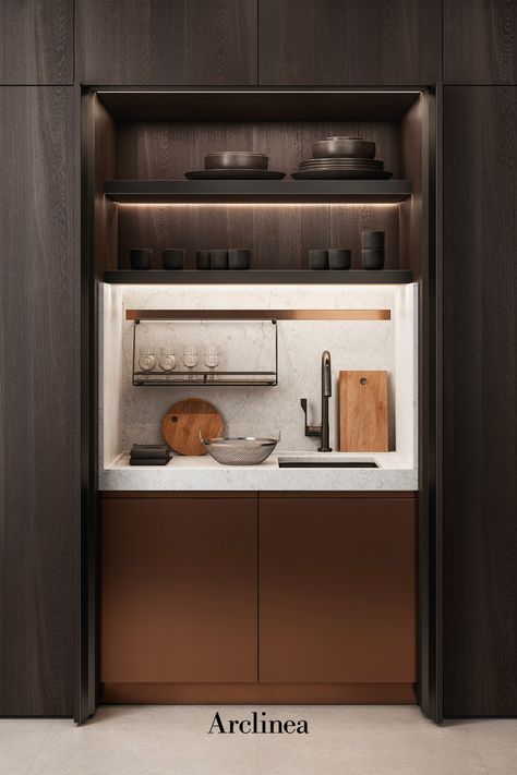 Small kitchen, the Arclinea New Pocket System door solution that creates an hidden mini-kitchen with brass kitchen doors and white marble worktop. Ideal kitchen solution for hotel rooms, small apartments and home living spaces with wooden walls. Disappearing Pantry Doors, Mini Pantry Cabinet, Hidden Kitchen Office, Pantry Living Room, Hidden Storage Cabinet, Concealed Kitchen Cabinets, Kitchenette In Living Room, Kitchen Hidden Cabinets, Hotel Suite Kitchen