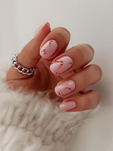 This candy cane-inspired nail art brings the sweetness of the season right to your fingertips. Featuring delicate red and white candy canes on a pale pink base, this fun and festive look is perfect for Christmas, adding a touch of holiday cheer to your winter wardrobe. Christmas Candy Nails, Candy Cane Nails, Red Christmas Nails, Red White Christmas, Festive Look, White Candy, Xmas Nails, Red Candy, Classy Nails