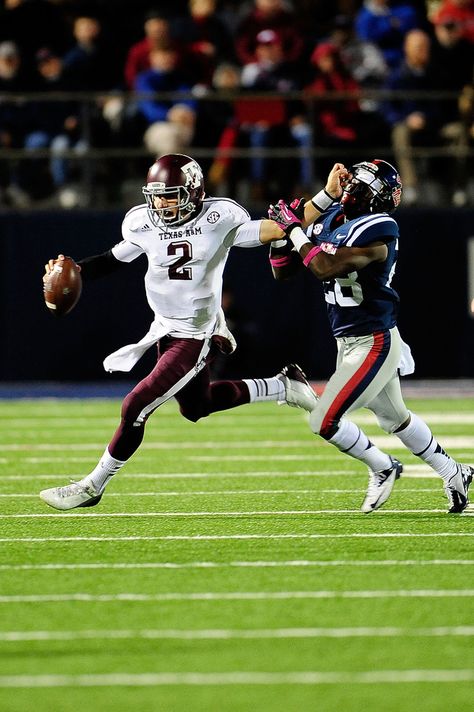 Johnny Manziel #2 of the Texas A&M Aggies stiff arms LaKedrick King #28 of the Ole Miss Rebels during a game at Vaught-Hemingway Stadium on October 6, 2012 in Oxford, Mississippi. Johnny Football, A&m Football, Aggie Football, Gig Em Aggies, Johnny Manziel, Heisman Trophy Winners, Heisman Trophy, Big Board, Ole Miss Rebels