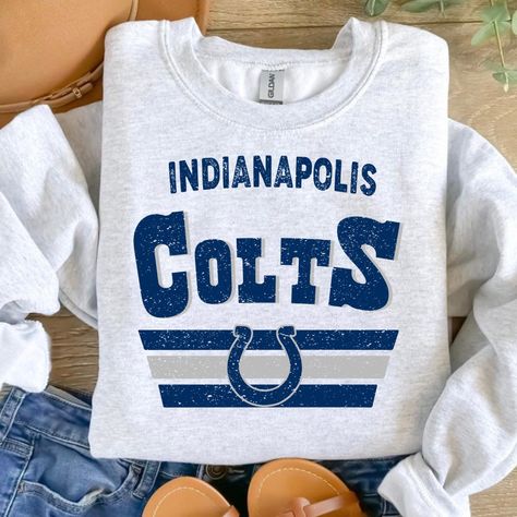 The Indianapolis Colts Crewneck is a stylish and comfortable addition to any fan's wardrobe. Crafted from a lightweight, moisture-wicking fabric, it is designed to keep you cool and dry, whether you're cheering from the stands or watching from home. The bold blue and white color scheme is sure to make a statement anywhere. SWEATSHIRTS ARE UNISEX and true to size if you like them oversized just go up one Colts Svg, Nfl Colts, Indianapolis Colts Logo, Horseshoe Logo, Colts Football, Creative Playground, Bowling Green Ky, Nfl History, Shirt Sayings