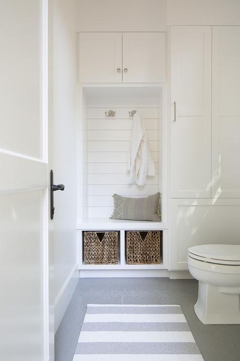 Bathroom in mudroom features an under window toilet alongside a white and gray stripe rug layered atop a gray penny tiled floor. Pool Towel Storage, Pool House Bathroom, Penny Tile Floors, Window Mudroom, Living Pool, Shiplap Backsplash, Tiled Floor, Stripe Rug, Pool Bathroom