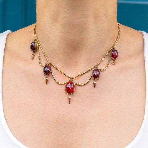 This Victorian 18ct Gold Garnet Fringe Necklace, with a 58.00ct of wine red cabochon cut Garnets, exudes historical charm and refined elegance. The Garnets' vibrant red hues are beautifully complemented by the warm 18ct Gold setting, creating a captivating contrast. Crafted around 1880, this necklace is not only a remarkable piece of jewellery but also a testament to the exquisite craftsmanship of the Victorian period.  Perfect for special occasions or as a cherished addition to any jewellery co Historian Outfit, Wire Sculpting, Eldest Daughter, Historical Jewellery, Victorian Period, Fringe Necklace, Product Ideas, Blog Instagram, Art Historian