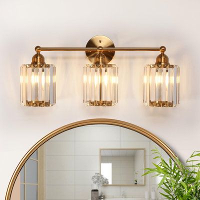 Transform your sophisticated bathroom, living room, or bedroom into a haven of sheer elegance with our opulent 3-light dimmable bathroom vanity light. The captivating electroplated brass finishes seamlessly merge with the crystal-adorned glass shade, introducing a touch of modern luxury and extravagant allure to your intimate spaces. Regardless of your decor style, this vanity light stands out as a unique decorative element, adding a touch of extravagant charm to your home. Elevate your home's a Powder Room Lighting, Gold Light Fixture, Gold Bathroom Decor, Sophisticated Bathroom, Door Hardware Interior, Bathroom Vanity Light, Vanity Lights, Gold Bathroom, Modern Glam