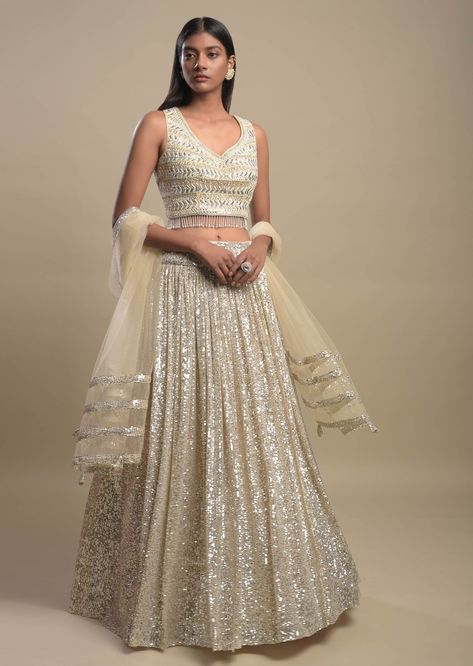 A little shine never hurt anybody, so why not glam up your wedding with some shimmer on your bridal lehengas! We have seen brides going from a classic red colour lehenga to a pastel one. But the one fashion trend that will never go out of style is the shimmer and sequin! It doesn’t matter what function you are attending, you can never go wrong with shimmer lehengas! #bridallehenga #trendinglehenga #latestbridallehenga #uniquelehengaideas #indianbridallehenga #sequinlehenga Checkered Embroidery, Shimmer Lehenga, Astha Narang, White Lehenga Choli, Grey Lehenga, Indian Bridal Lehenga, Padded Blouse, Embroidered Belt, Choli Designs