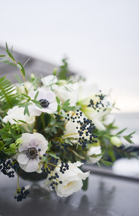 Green and white centerpiece with black accents for beachfront wedding at Gurney's in Montauk Long Island. September wedding. White garden roses, anemones, berries, lisianthus and mix of eucalyptus greenery. Rosehip Social Florist. Green And White Centerpiece, Anemone Centerpiece, Black And White Centerpieces, Greenery Centerpieces, Montauk Long Island, White Garden Roses, Black Centerpieces, Anemone Wedding, White Floral Centerpieces