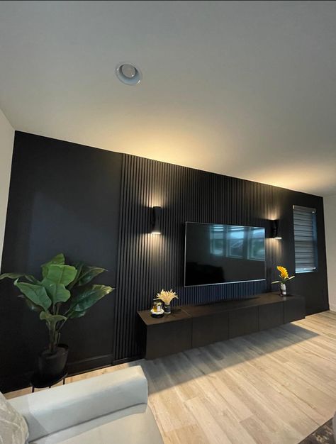 Black Tv Feature Wall, Tv With Paneling, 70” Tv Wall, Deep Green Interior Design, High Tv Wall Ideas, Panels Behind Tv, Black And Wood Tv Wall, Tv Wall Black And Wood, Black Wood Tv Wall