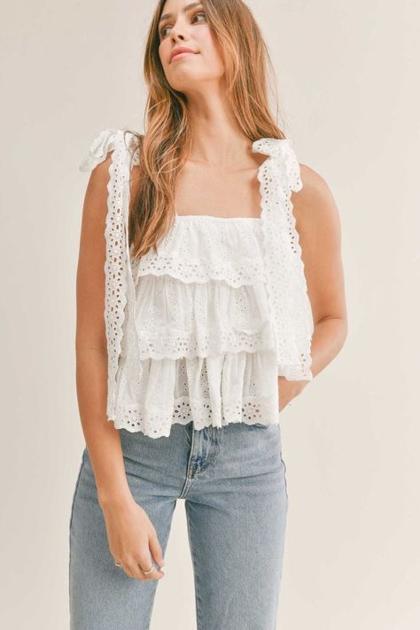 Summer love is in the air with this Embroidered Tier Top. With its playful sleeveless design, ruffle tiered lace, and delicate lace shoulder straps, it's the perfect addition to any warm weather wardrobe. Bring out your inner romantic in this flirty and feminine babydoll top. Cute Summer Tops Modest, Pretty Swimsuits, Cute White Tops, Denim Embroidery, Summer Shopping, Cottagecore Outfits, Tiered Tops, Senior Picture Outfits, Senior Photoshoot