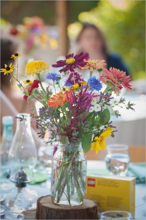 colorful wildflower centerpiece #weddingreception #wildflowers #weddingchicks http://www.weddingchicks.com/2014/02/26/fun-and-feisty-forest-wedding/ Wildflower Centerpieces, Wedding Centerpieces Mason Jars, Rustic Boho Wedding, Unique Wedding Flowers, Mason Jar Wedding, Wildflower Bouquet, Flower Centerpieces Wedding, Wildflower Wedding, Wedding Table Centerpieces