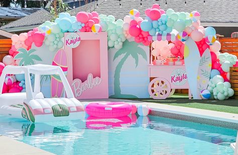 Pool with big malibu Barbie backdrop. Colorful balloons Pool Party Beach Theme, Malibu Barbie Birthday Party Food, Barbie Pool Party Ideas Decoration, Hawaiian Barbie Party, Malibu Barbie Pool Party Ideas, Malibu Pool Party, Malibu Beach Barbie Party, Malibu Barbie Theme, Barbie Swim Party