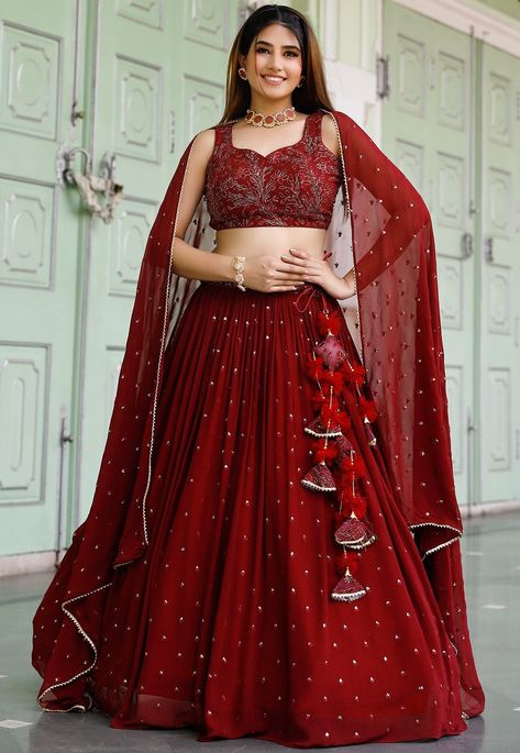 Faux Georgette Lehenga in Maroon. This attire with Cotton Lining is Enhanced with Resham, Zari And Sequins Work, Fancy Gota Border On Dupatta along with Fancy Tassels. Available with a Readymade Faux Georgette Maroon Choli and a Faux Georgette Dupatta in Maroon.The Readymade skirt will be provided. Lehenga Length is 40 inched. Do Note: Accessories shown in the image are for presentation purposes only and length may vary upto 2 inches.(Slight variation in actual color vs. image is possible). We s Lehanga Styles Modern, Simple Georgette Lehenga Designs, Simple Lehenga For Engagement, Roka Poses, Lehenga Stitching Ideas, Lehnga Designs Indian Weddings Simple, Modern Lehangas, Lengha Design, Indowestern Lehenga