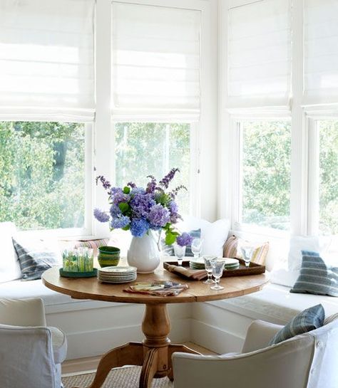 round table breakfast nook with banquette seating Modern Farmhouse Sunroom, Creative Window Treatments, Farmhouse Sunroom, Repurposed Window, Breakfast Nooks, Sunroom Designs, Banquette Seating, Nate Berkus, Kitchen Nook